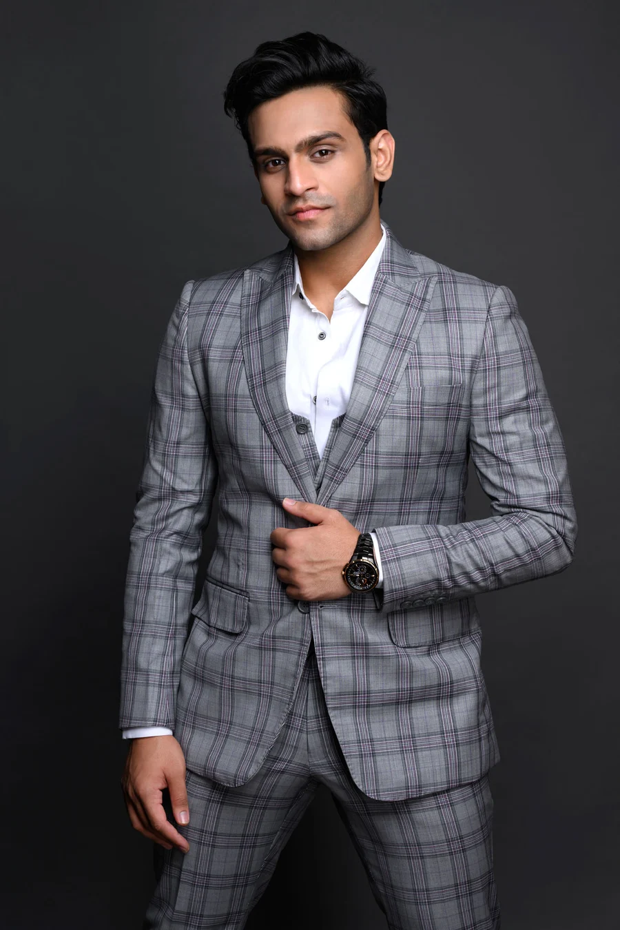 Siddhant Jain, founder of Sidiore, standing in a grey checked suit, facing the camera.